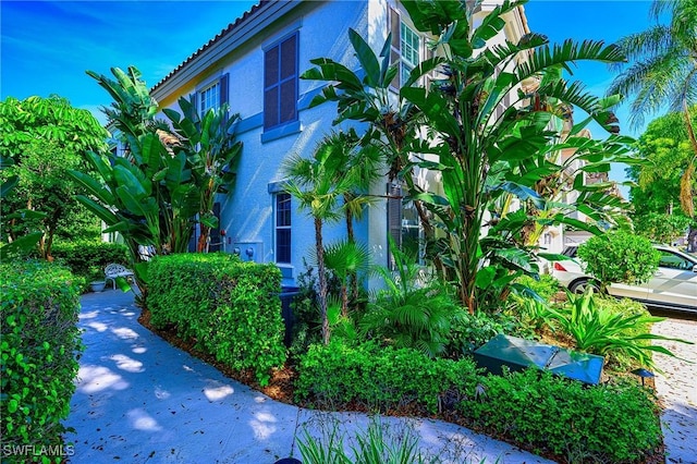 133 Colonade Cir, Naples, FL 34103 - view of home's exterior featuring stucco siding and a tiled roof