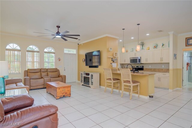 18370 Tulip Rd, Fort Myers, FL 33967 - living area with light tile patterned flooring, crown molding, ceiling fan, recessed lighting, and baseboards