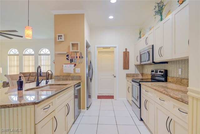 18370 Tulip Rd, Fort Myers, FL 33967 - kitchen featuring stainless steel appliances, a sink, backsplash, light stone countertops, and recessed lighting