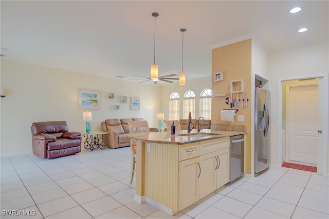 18370 Tulip Rd, Fort Myers, FL 33967 - kitchen with stainless steel appliances, open floor plan, a sink, a kitchen bar, and light stone counters