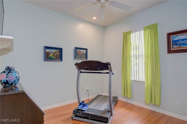18370 Tulip Rd, Fort Myers, FL 33967 - exercise room with light wood-type flooring, ceiling fan, and baseboards