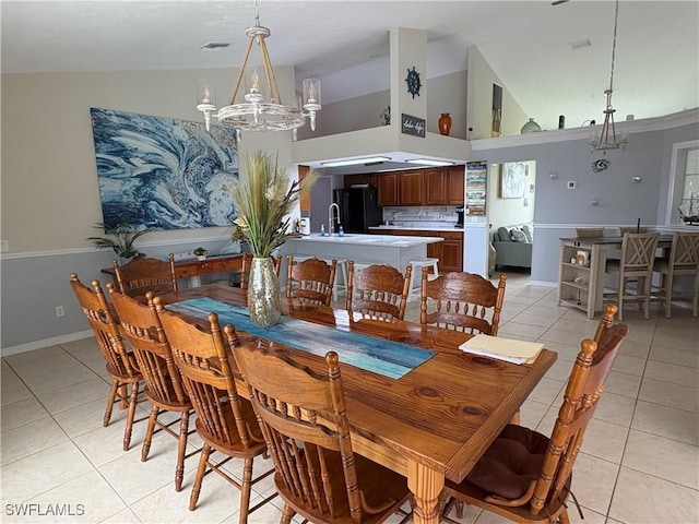1118 Grove Dr, Naples, FL 34120 - dining area featuring a chandelier, light tile patterned floors, and high vaulted ceiling