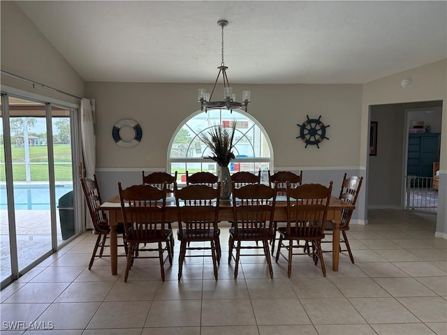 1118 Grove Dr, Naples, FL 34120 - dining space with a chandelier, healthy amount of natural light, vaulted ceiling, and light tile patterned floors
