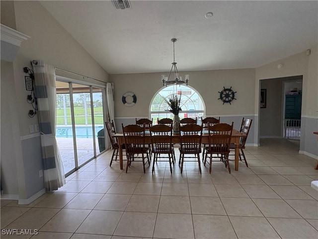 1118 Grove Dr, Naples, FL 34120 - dining room with healthy amount of natural light, light tile patterned flooring, vaulted ceiling, and a chandelier