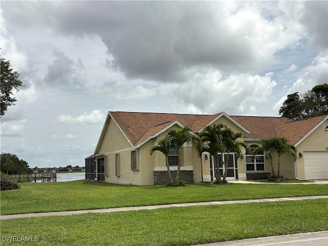 1118 Grove Dr, Naples, FL 34120 - view of front of home featuring stucco siding, a front yard, a garage, and a water view
