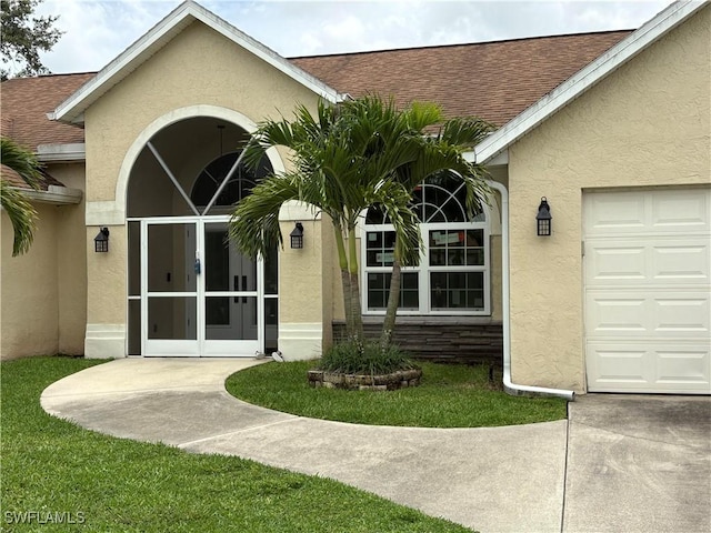 1118 Grove Dr, Naples, FL 34120 - view of exterior entry with stucco siding, french doors, roof with shingles, and an attached garage