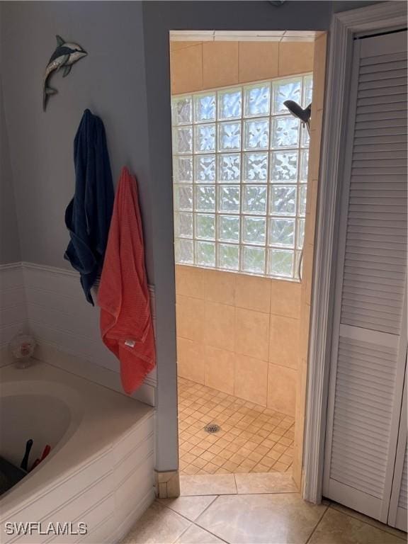 1118 Grove Dr, Naples, FL 34120 - full bath featuring a garden tub, a stall shower, a closet, and tile patterned flooring