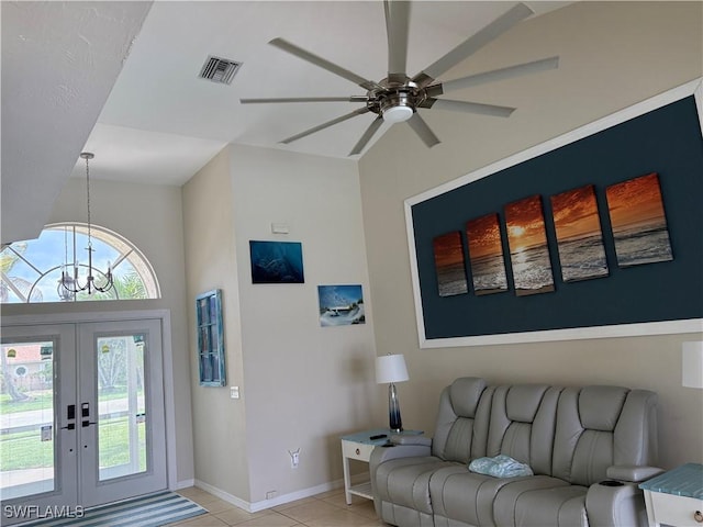1118 Grove Dr, Naples, FL 34120 - living room with ceiling fan, light tile patterned floors, a chandelier, and french doors