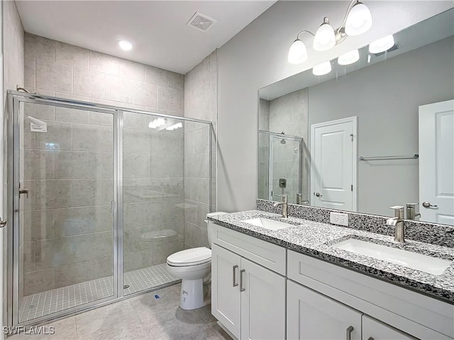 3307 55th St W, Lehigh Acres, FL 33971 - bathroom featuring double vanity, a shower stall, toilet, and tile patterned floors
