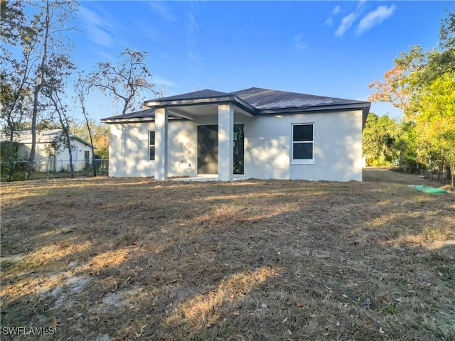 3307 55th St W, Lehigh Acres, FL 33971 - rear view of house with stucco siding