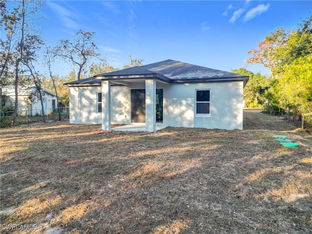 3307 55th St W, Lehigh Acres, FL 33971 - back of house featuring stucco siding
