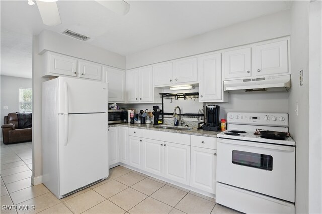 11580 Dean St Unit 582, Bonita Springs, FL 34135 - kitchen with white appliances, under cabinet range hood, a sink, and white cabinetry