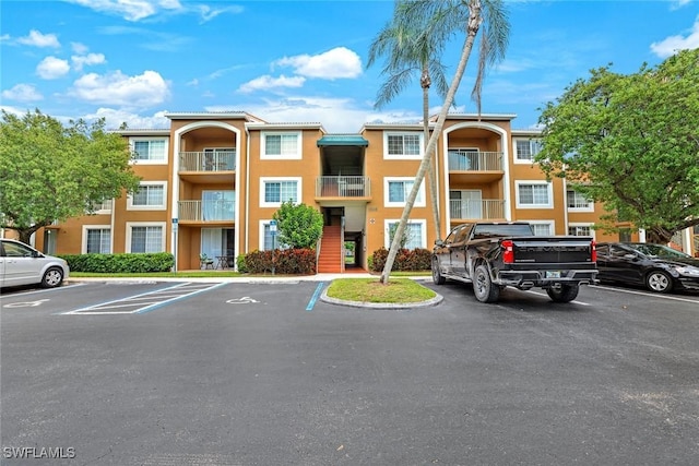 1205 Wildwood Lakes Blvd Unit 305, Naples, FL 34104 - view of property featuring uncovered parking