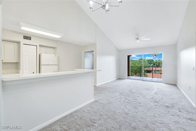 1205 Wildwood Lakes Blvd Unit 305, Naples, FL 34104 - unfurnished living room with light colored carpet, a chandelier, high vaulted ceiling, and ceiling fan