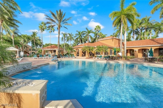1205 Wildwood Lakes Blvd Unit 305, Naples, FL 34104 - community pool with a patio area
