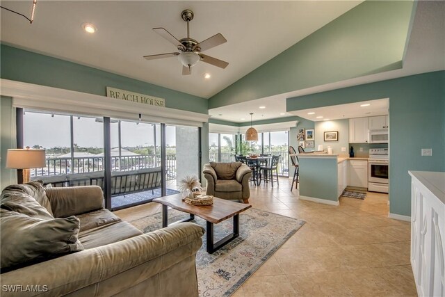 16641 Stringfellow Rd Unit 506, Bokeelia, FL 33922 - living room featuring ceiling fan, lofted ceiling, light tile patterned flooring, recessed lighting, and baseboards