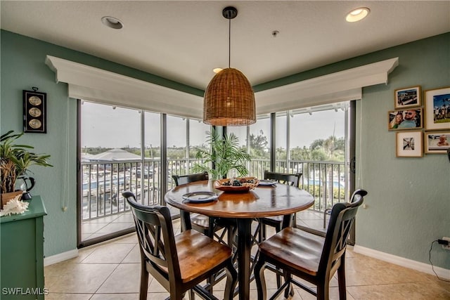 16641 Stringfellow Rd Unit 506, Bokeelia, FL 33922 - dining space featuring healthy amount of natural light, light tile patterned flooring, baseboards, a textured wall, and recessed lighting