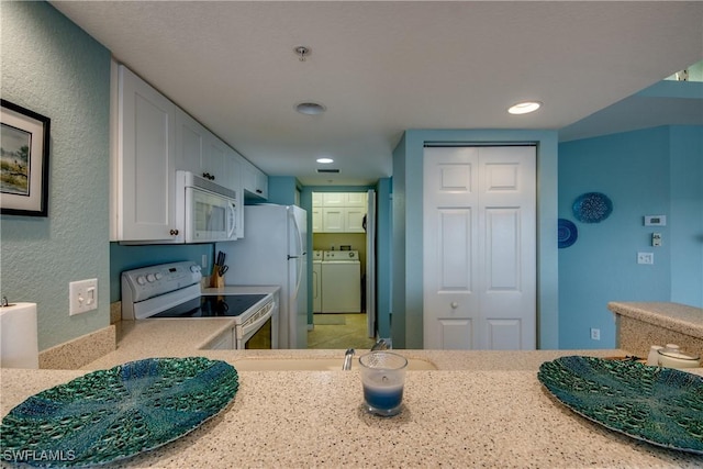 16641 Stringfellow Rd Unit 506, Bokeelia, FL 33922 - kitchen with white appliances, light countertops, recessed lighting, a textured wall, and washer and clothes dryer