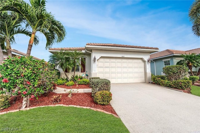 10412 Materita Dr, Fort Myers, FL 33913 - mediterranean / spanish-style home with an attached garage, driveway, a tiled roof, and stucco siding