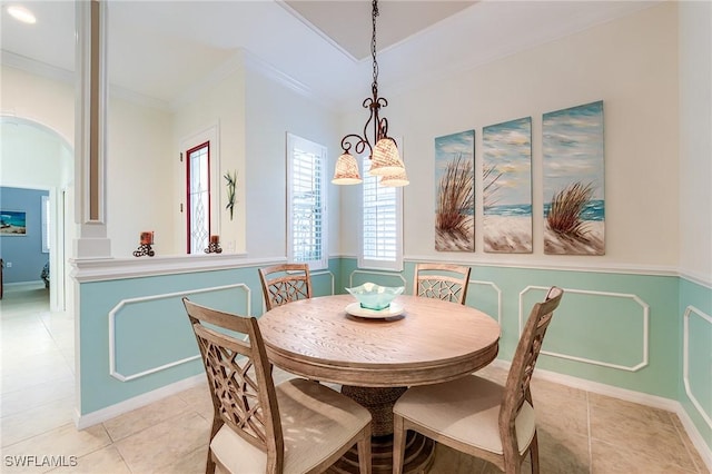10412 Materita Dr, Fort Myers, FL 33913 - dining room with crown molding, light tile patterned floors, wainscoting, and arched walkways