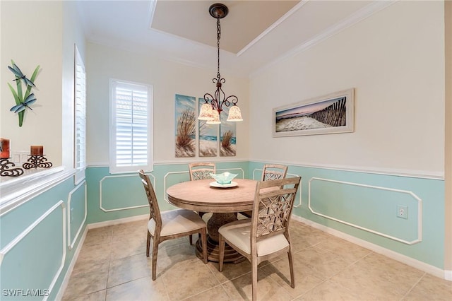 10412 Materita Dr, Fort Myers, FL 33913 - dining space with a wainscoted wall, light tile patterned flooring, ornamental molding, a raised ceiling, and a decorative wall
