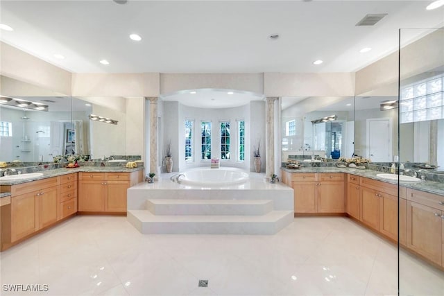 1658 Mcilvaine Ct, Marco Island, FL 34145 - bathroom featuring ornate columns, a garden tub, healthy amount of natural light, and recessed lighting