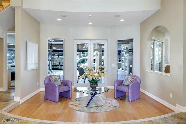 1658 Mcilvaine Ct, Marco Island, FL 34145 - living area featuring wood finished floors, arched walkways, a fireplace, baseboards, and recessed lighting