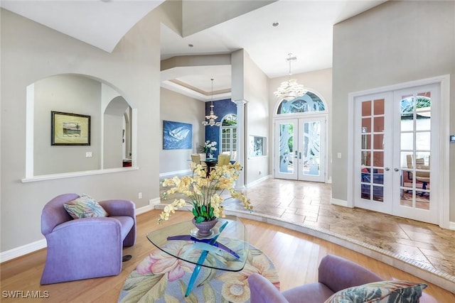 1658 Mcilvaine Ct, Marco Island, FL 34145 - living area featuring french doors, a chandelier, plenty of natural light, and baseboards