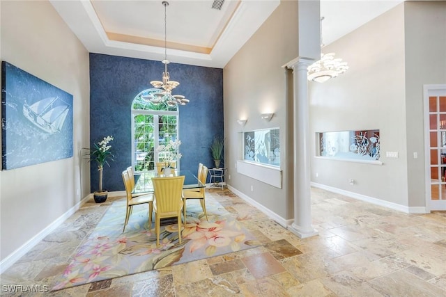 1658 Mcilvaine Ct, Marco Island, FL 34145 - dining area with a chandelier, decorative columns, stone tile floors, baseboards, and a raised ceiling