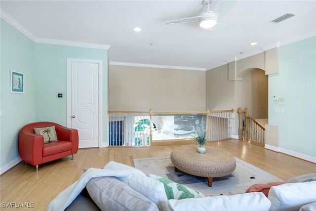 1658 Mcilvaine Ct, Marco Island, FL 34145 - living room with arched walkways, a ceiling fan, wood finished floors, ornamental molding, and baseboards