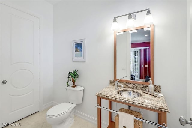 1658 Mcilvaine Ct, Marco Island, FL 34145 - half bath featuring a sink, toilet, tile patterned floors, and baseboards