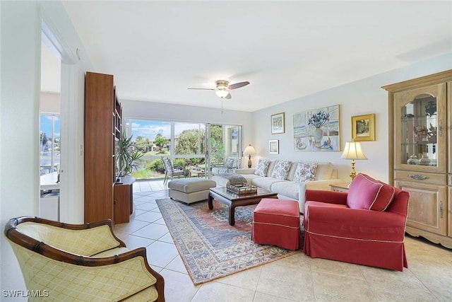 1250 Yesica Ann Cir Unit E106, Naples, FL 34110 - living area with light tile patterned floors and a ceiling fan