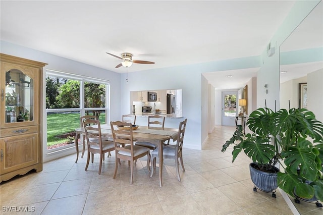 1250 Yesica Ann Cir Unit E106, Naples, FL 34110 - dining room with light tile patterned flooring and ceiling fan