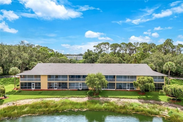 1250 Yesica Ann Cir Unit E106, Naples, FL 34110 - rear view of house featuring a water view and a lawn