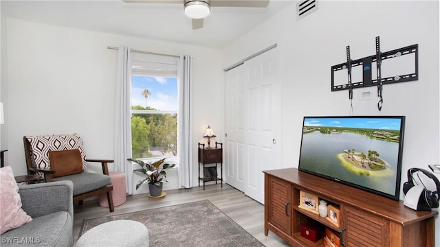 9640 Victoria Ln Unit C308, Naples, FL 34109 - living area with a ceiling fan and light wood-style flooring