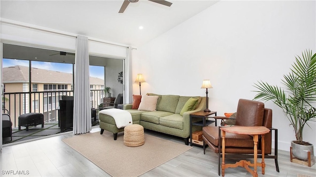 9640 Victoria Ln Unit C308, Naples, FL 34109 - living room featuring a ceiling fan, vaulted ceiling, and wood finished floors