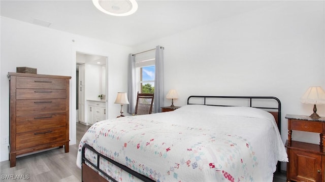 9640 Victoria Ln Unit C308, Naples, FL 34109 - bedroom with wood finished floors and ensuite bathroom