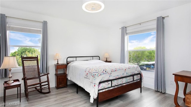 9640 Victoria Ln Unit C308, Naples, FL 34109 - bedroom featuring light wood finished floors and multiple windows