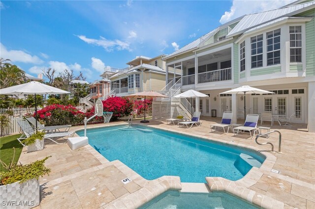 11533 Andy Rosse Ln, Captiva, FL 33924 - view of pool with stairway, a patio, a sunroom, and a pool with connected hot tub