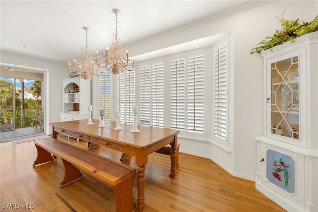 11533 Andy Rosse Ln, Captiva, FL 33924 - dining room with a chandelier, light wood-style flooring, and baseboards