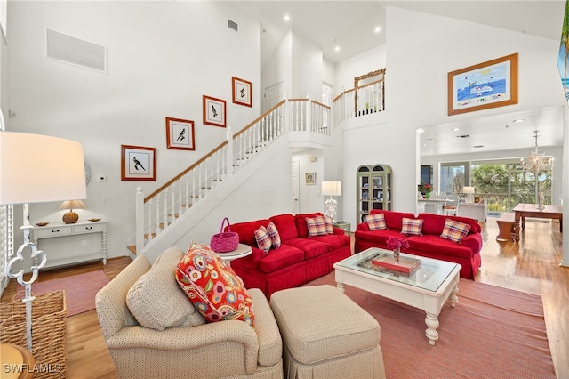 11533 Andy Rosse Ln, Captiva, FL 33924 - living room with stairway, wood finished floors, a towering ceiling, and recessed lighting