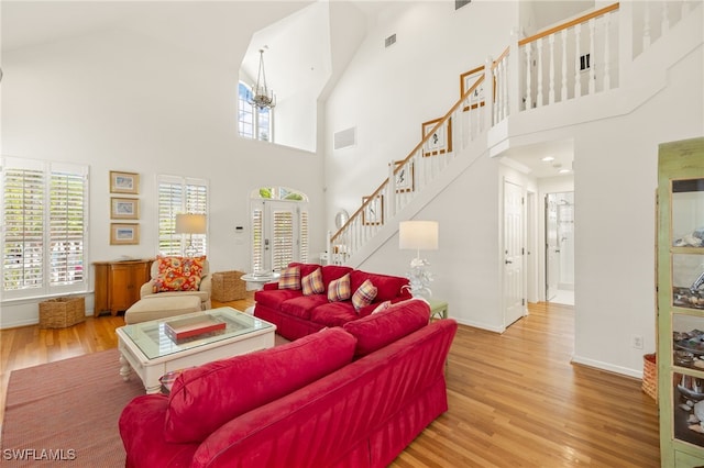 11533 Andy Rosse Ln, Captiva, FL 33924 - living room featuring stairs, high vaulted ceiling, wood finished floors, plenty of natural light, and baseboards