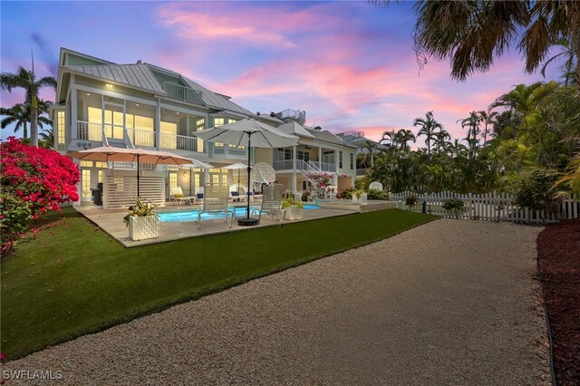 11533 Andy Rosse Ln, Captiva, FL 33924 - back of house with an outdoor pool, a balcony, a sunroom, and a patio area