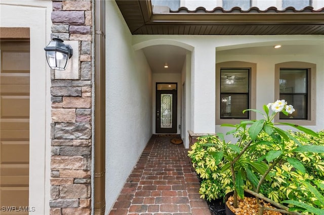 10996 Cherry Laurel Dr, Fort Myers, FL 33912 - doorway to property with stone siding and stucco siding