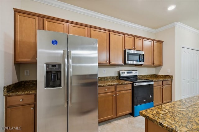 10996 Cherry Laurel Dr, Fort Myers, FL 33912 - kitchen featuring appliances with stainless steel finishes, brown cabinetry, crown molding, dark stone counters, and light tile patterned flooring