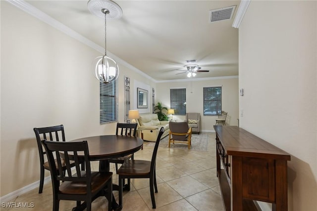 10996 Cherry Laurel Dr, Fort Myers, FL 33912 - dining space featuring a ceiling fan, crown molding, light tile patterned floors, baseboards, and a chandelier