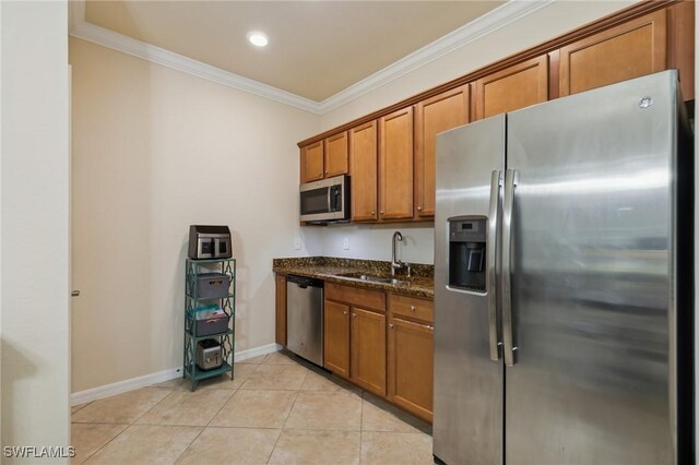 10996 Cherry Laurel Dr, Fort Myers, FL 33912 - kitchen with stainless steel appliances, a sink, brown cabinets, ornamental molding, and dark stone countertops