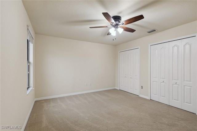 10996 Cherry Laurel Dr, Fort Myers, FL 33912 - unfurnished bedroom featuring carpet, baseboards, two closets, and ceiling fan