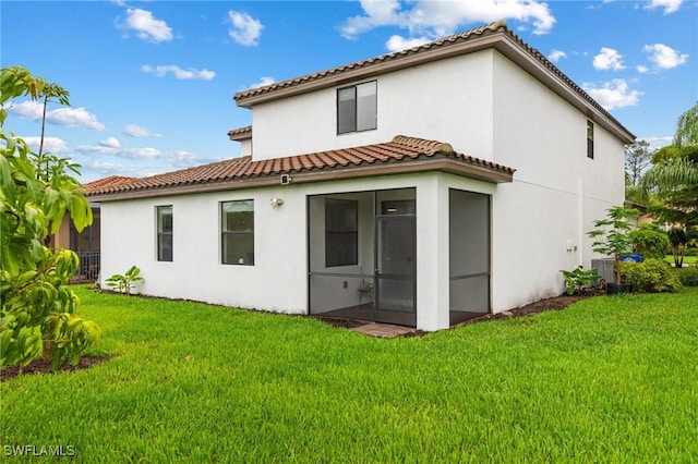 10996 Cherry Laurel Dr, Fort Myers, FL 33912 - back of house with a tile roof, stucco siding, a sunroom, and a yard