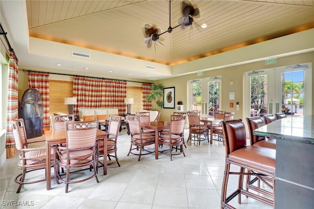 1050 Borghese Ln Unit 801, Naples, FL 34114 - dining space with french doors, a tray ceiling, light tile patterned floors, wood ceiling, and recessed lighting